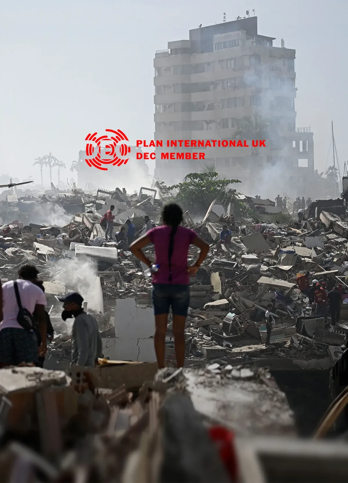 Volunteers search for survivors in a collapsed building following the twin earthquakes in La Guaira state, Venezuela