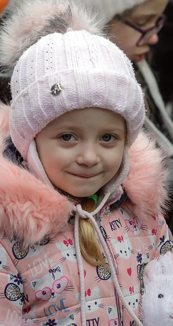 Julia, 5, clutches the toy rabbit she has received after arriving in Isaccea