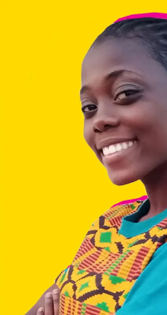 A girl standing against a yellow background smiling at the camera.