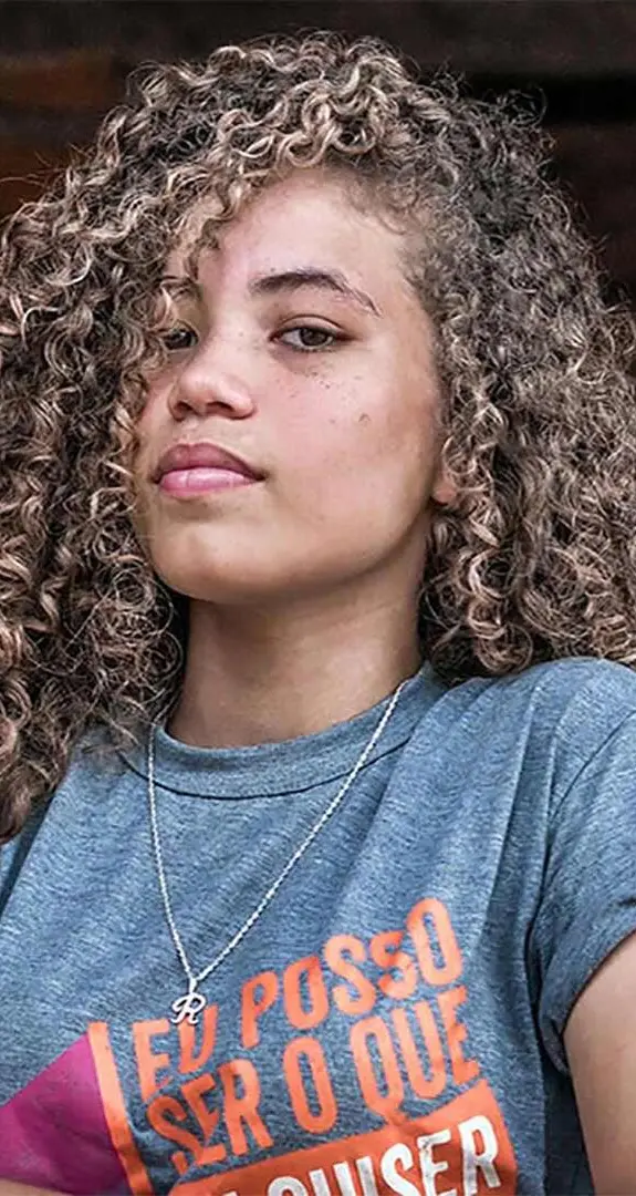 A girl with her arms crossed looking at the camera