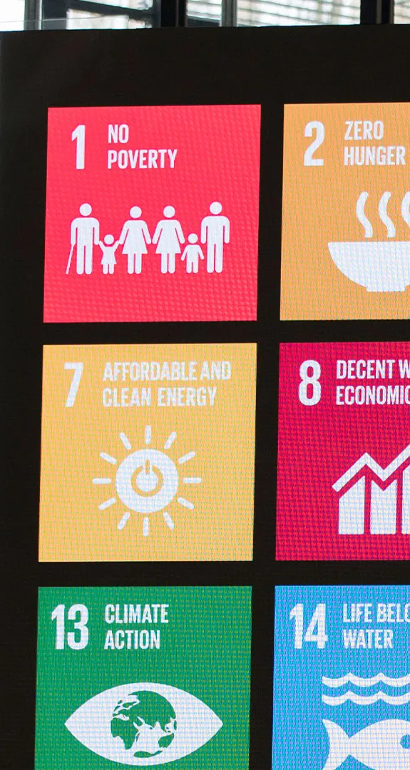 Large screen with graphics for all sustainable development goals displayed on it.