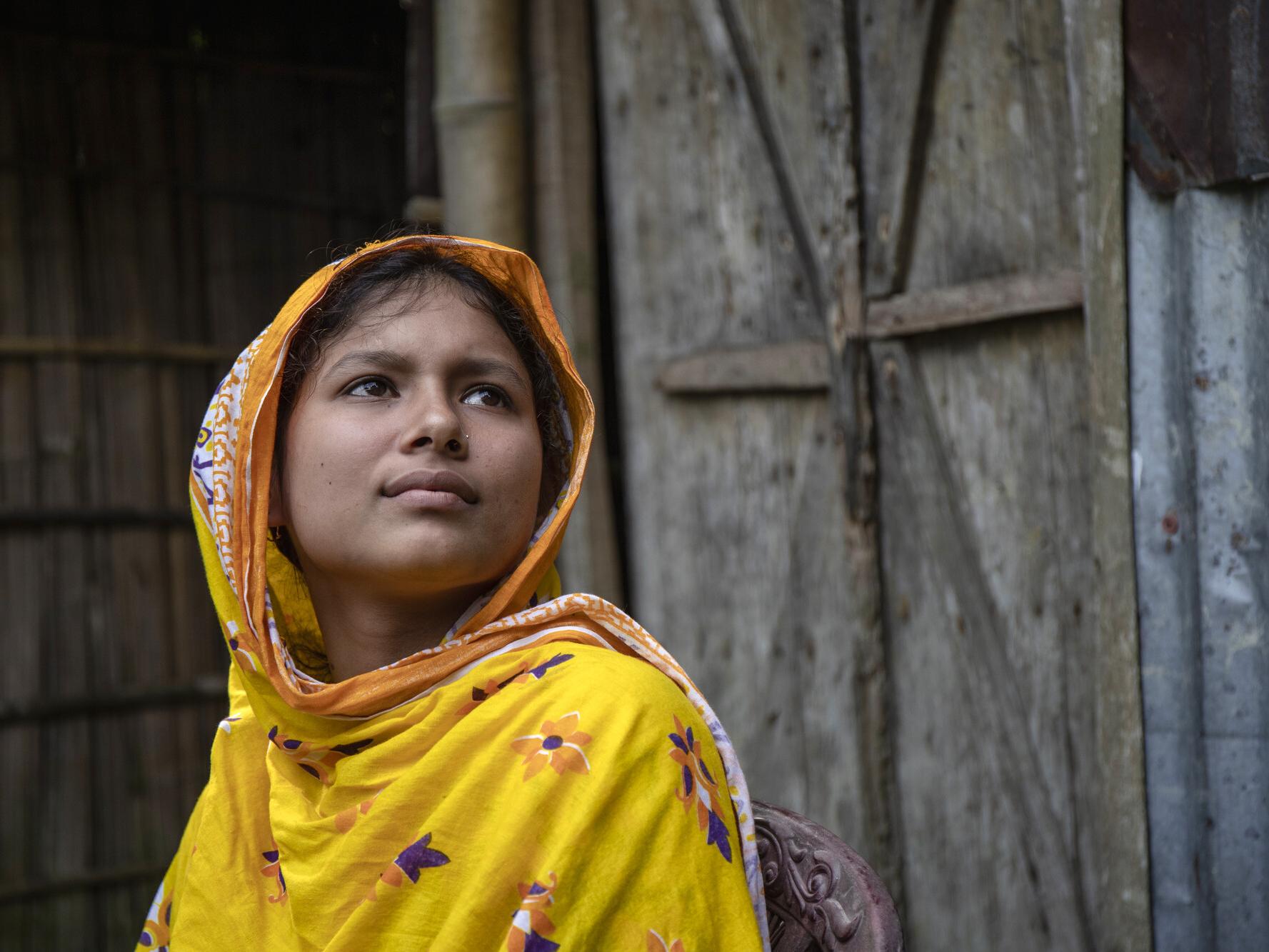 Monalisa, 15, looking into the distance in Bangladesh