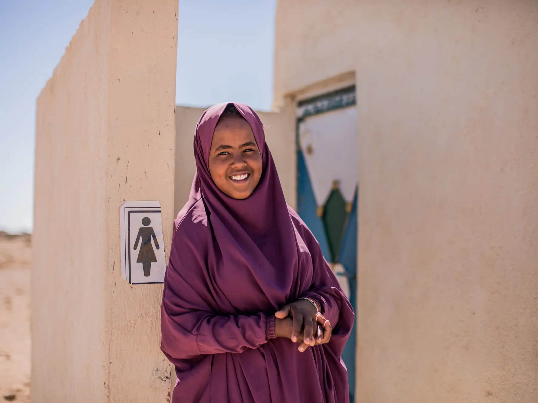 Hamda, 15, standing outside the new toilet facilities built by Plan International in Somalia