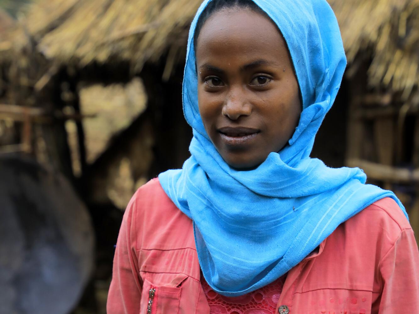 Debritu, 16, standing outside in a village in Ethiopia