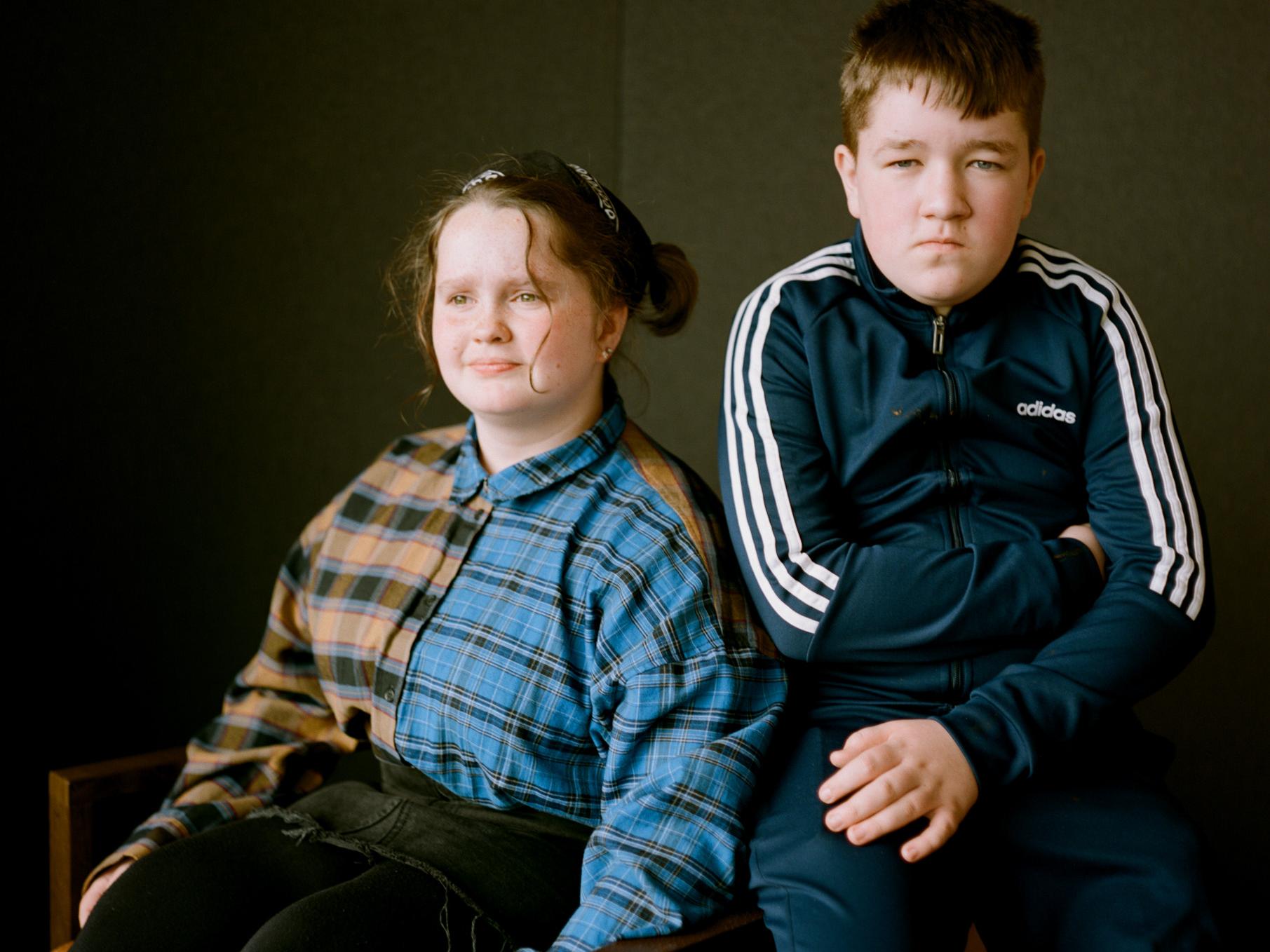 Molly, 13, and Connor, 11, from the Bolton Lads & Girls Club sitting and looking at the camera