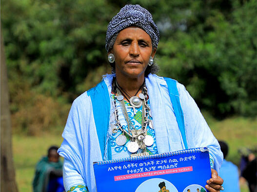 Abeba holding documents highlighting the consequences of child marriage