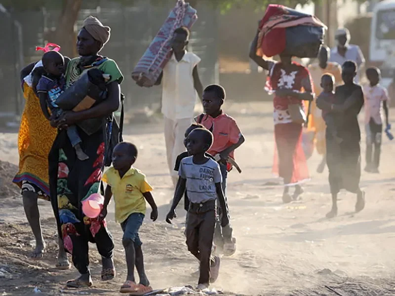 People flee their neighbourhoods amid fighting between the army and paramilitaries in Khartoum on April 19, 2023, following the collapse of a 24-hour truce.