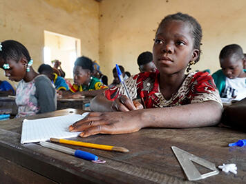 Diatou, 12, sitting at her desk in her school classroom in Mali