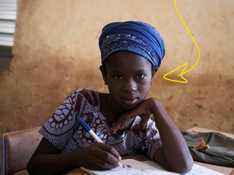 A girl looks at a camera