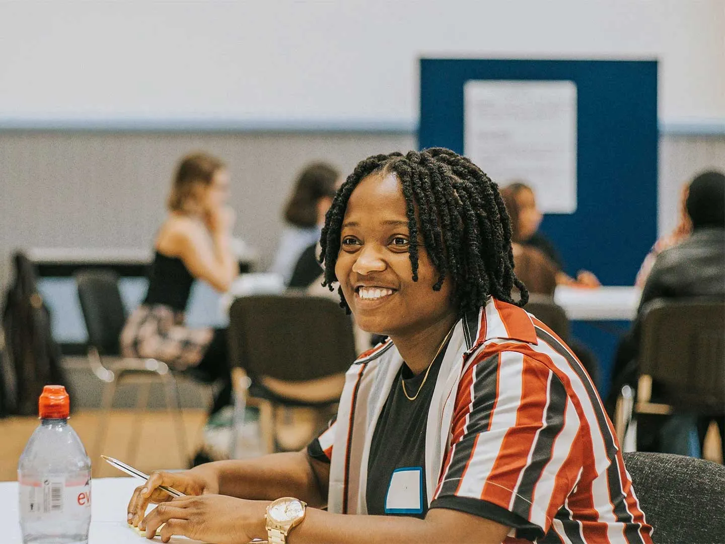 Taina, 22, smiles while taking part in a group activity