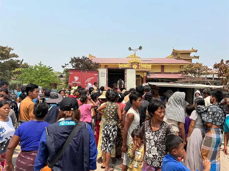 Crowd of people outside mosque in Mandalay.