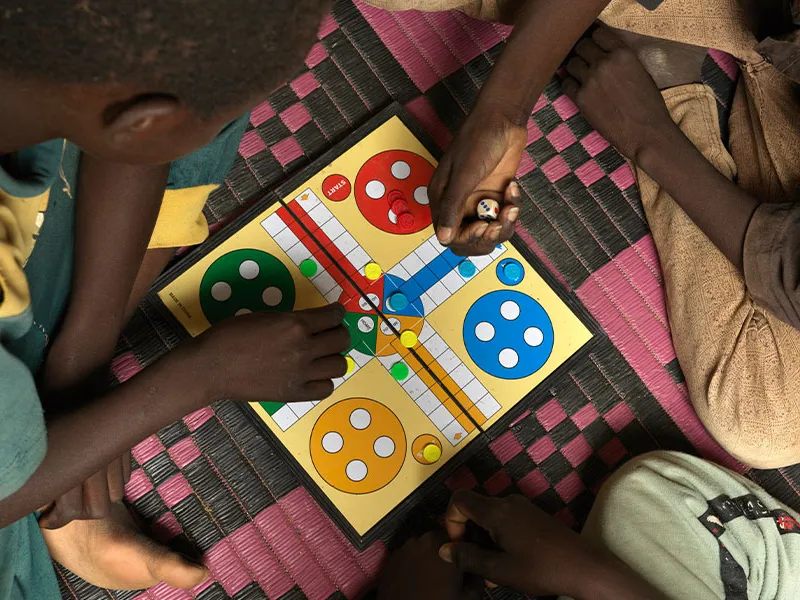 Birds eye view of children playing ludo