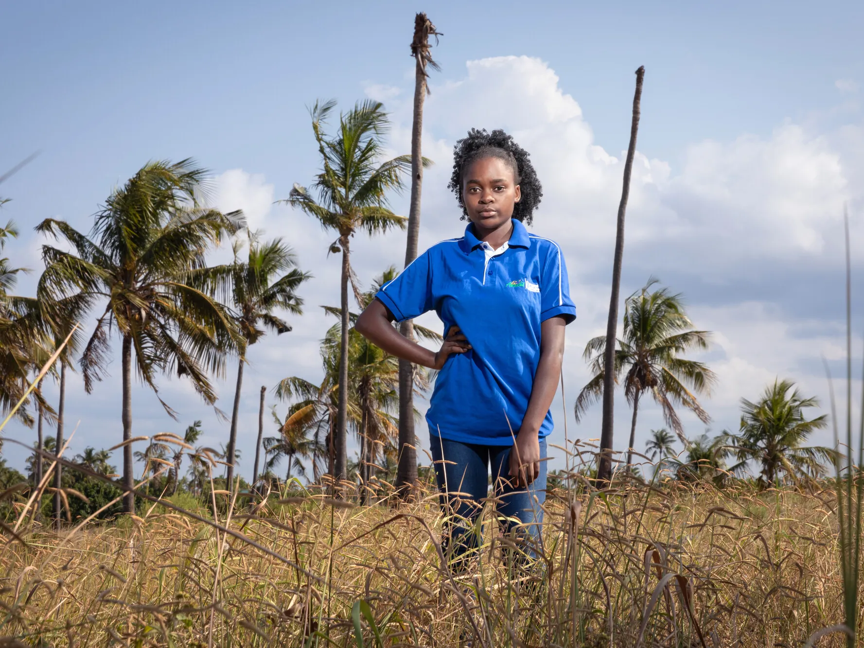Eunice, 18, stands in a field in Mozambique. She is passionate about defending the rights of girls 