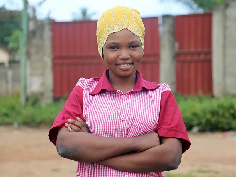 Roumana standing outside with arms crossed