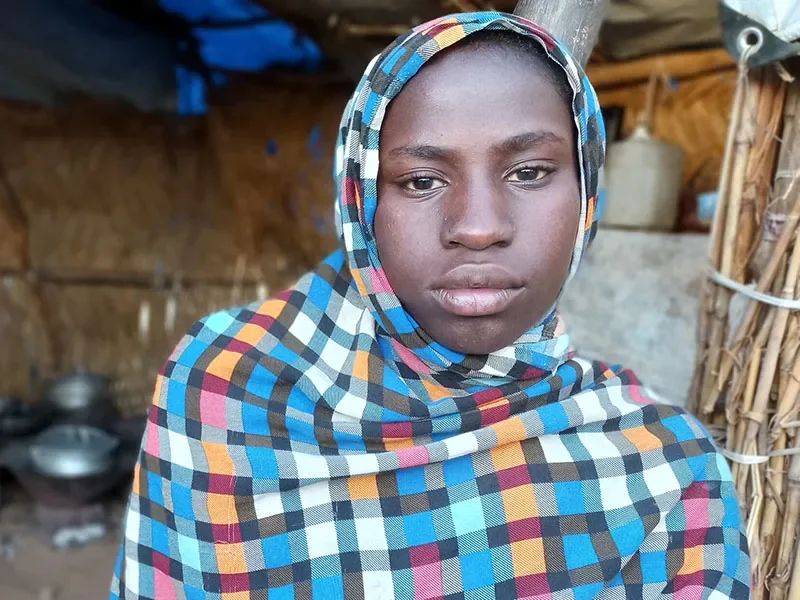 Mehad, 16, from Sudan, is outside her home.