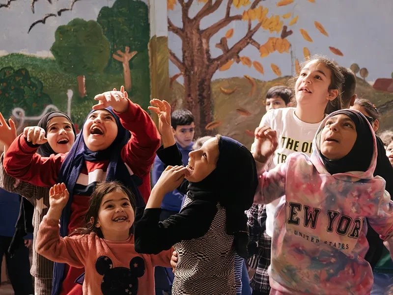 Children take part in an organised play session in Beirut. They are playing in a school shelter.
