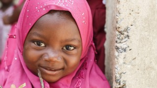 Girl smiling at an Early Childhood Care Centre in Tanzania