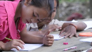 Sponsored children writing letters and making drawings to send to their sponsors